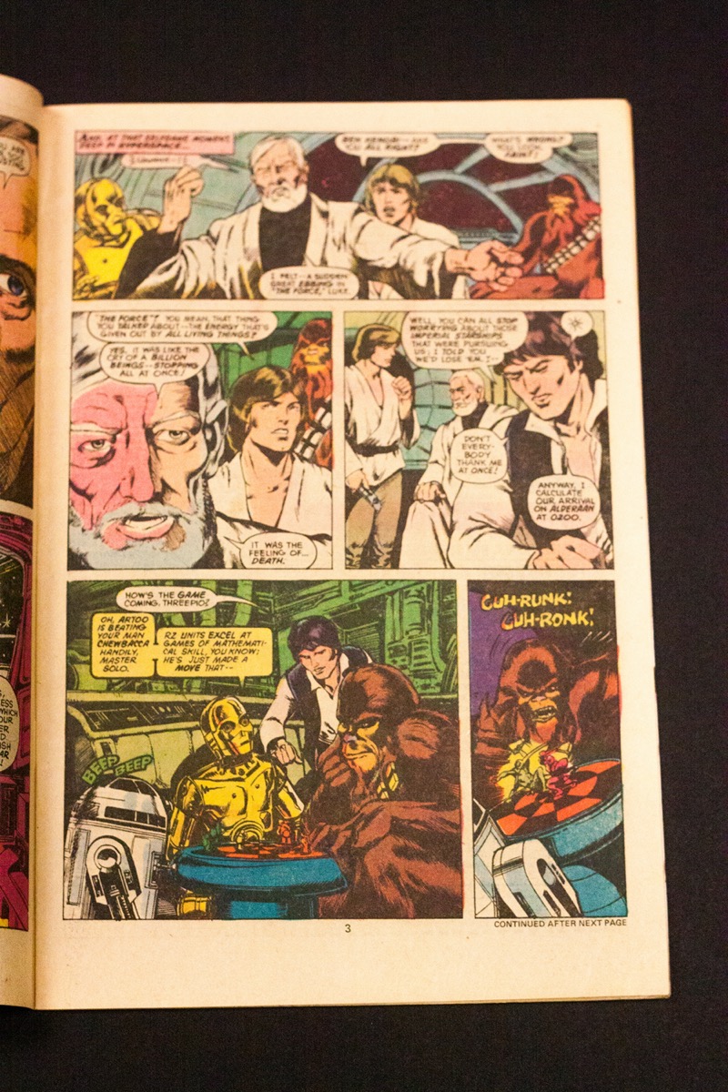 A comic book page with a long panel at the top, two panels in the middle, and two panels at the bottom.
