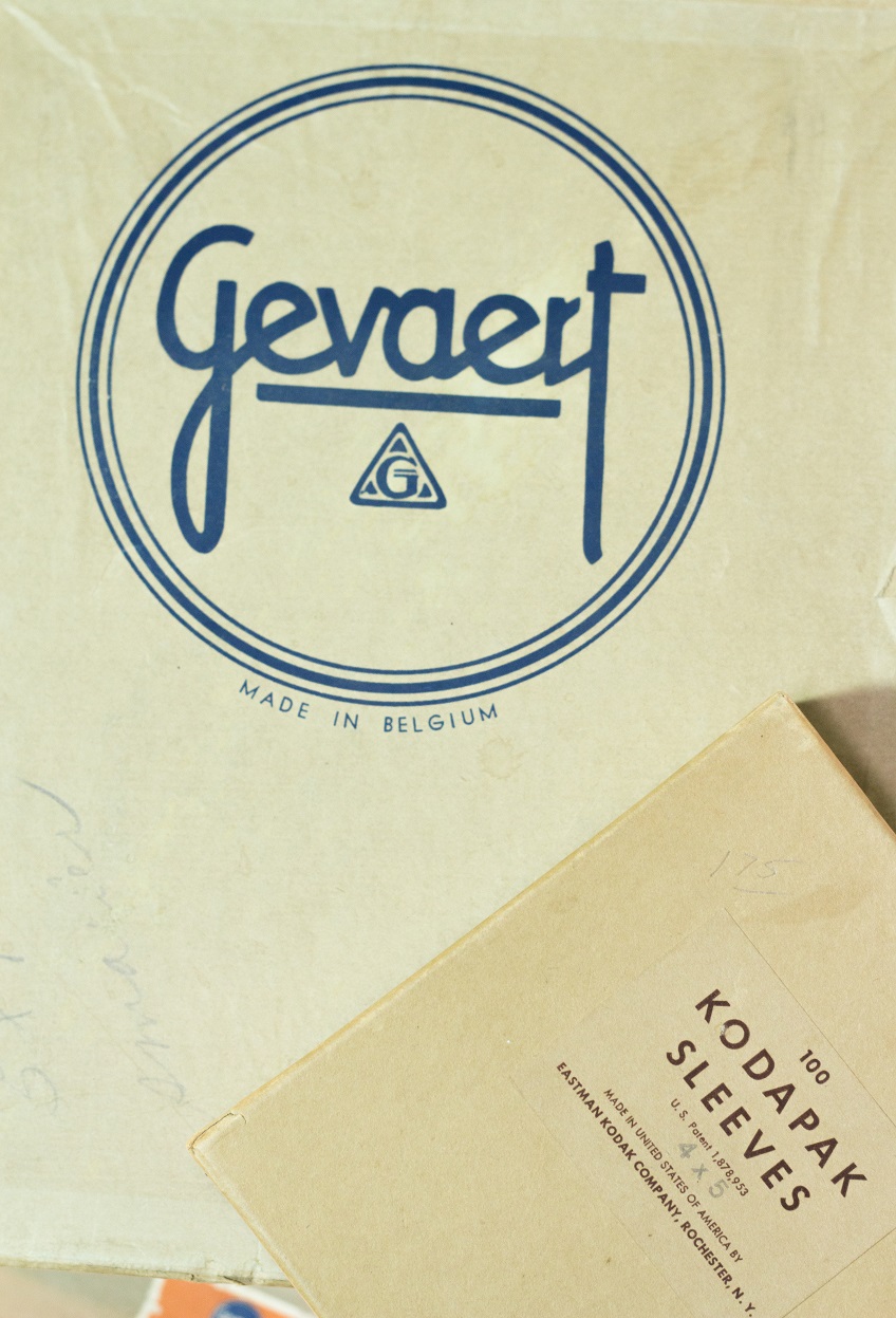 A paper box with the word Kodak Sleeves on it, on a surface with a big blue stamp on it, the word Gevaert on it.