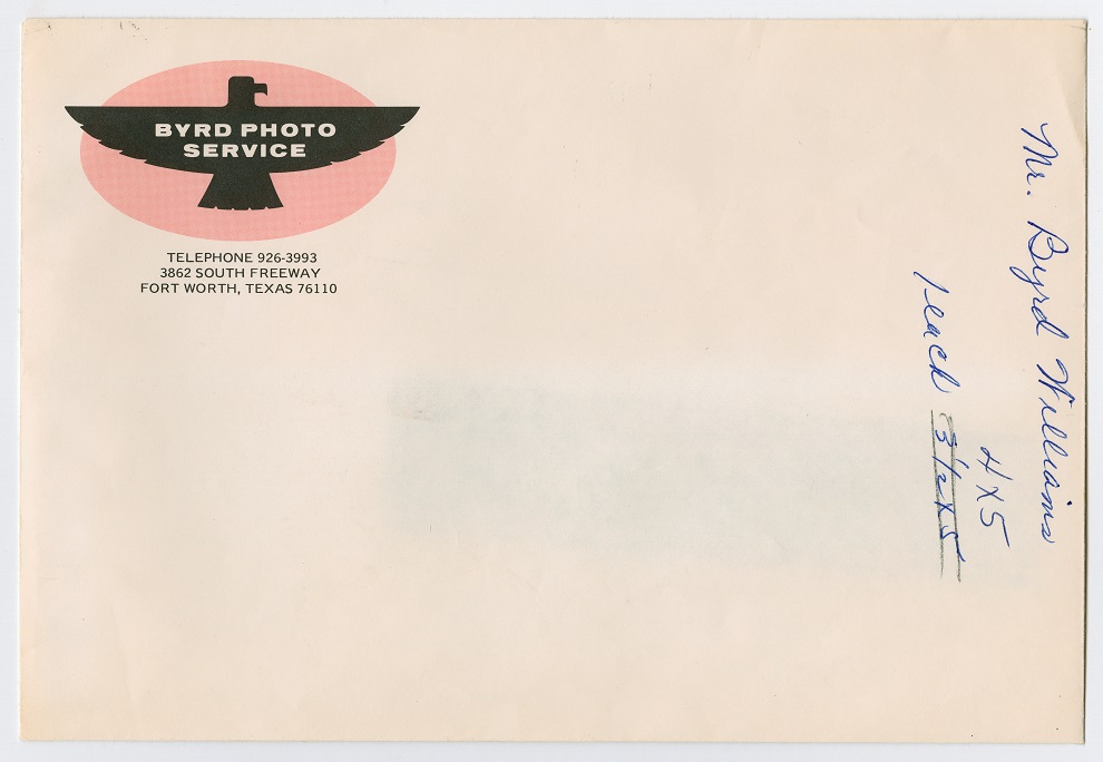 A white envelope, a graphic of an eagle in the top left corner. The right margin has some writing on it in blue ink.
